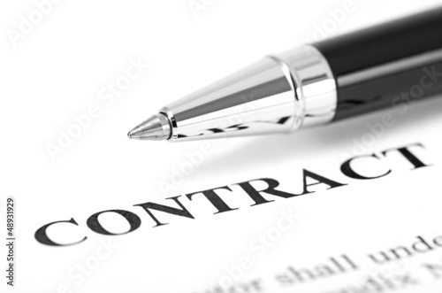 Close-up of silver pen on contract.