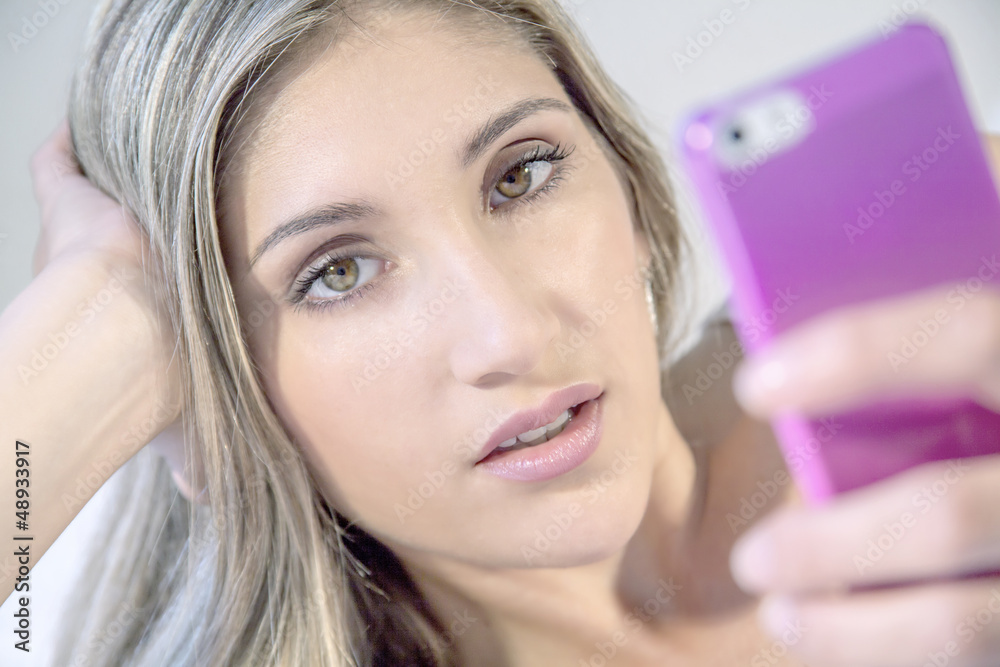 Fototapeta premium young beautiful woman with phone