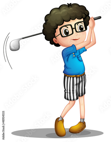 A young boy playing golf