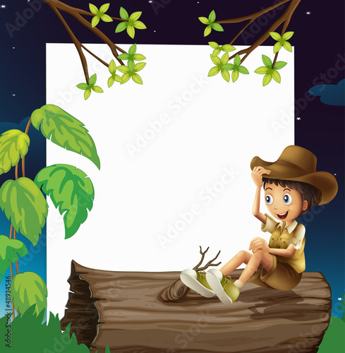 A boy sitting on a trunk