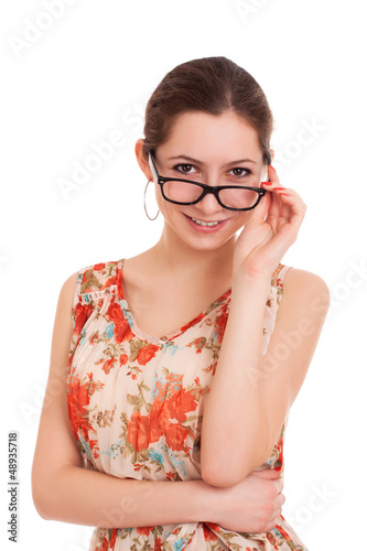 Portrait of young woman looking over glasses