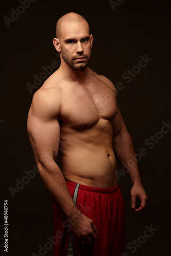 Muscular male body black background