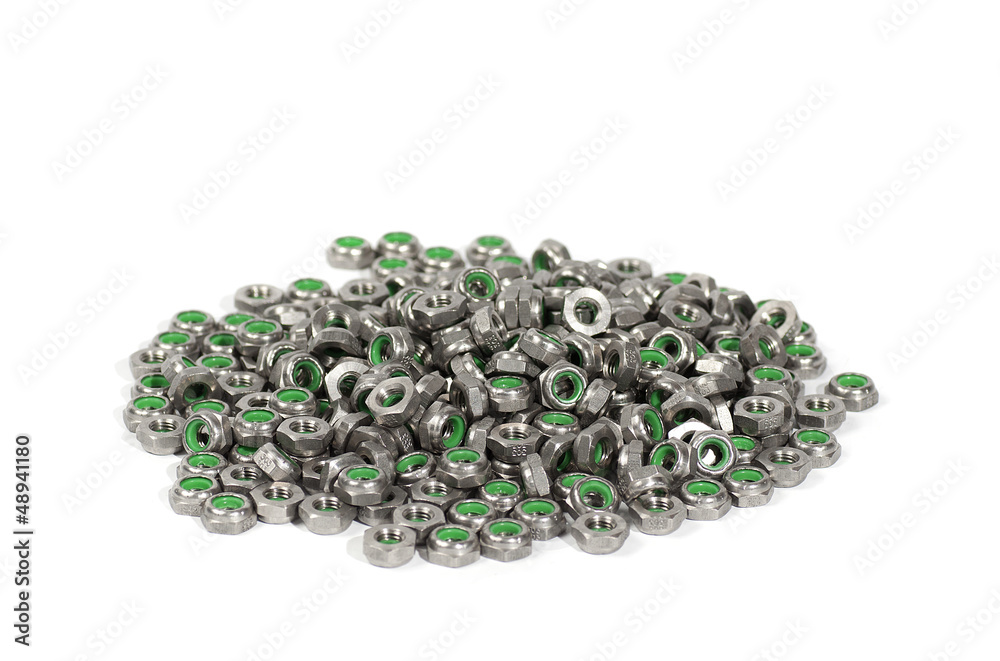 heap of metal nuts with green interior, stacked heap of metal nuts with green interior, stacked