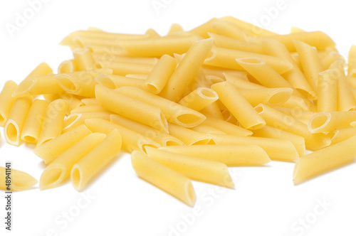 Some raw penne macaroni isolated on white background