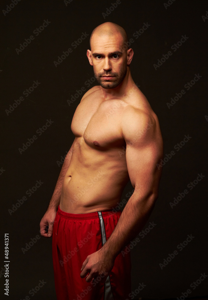 Fototapeta premium Muscular male body black background