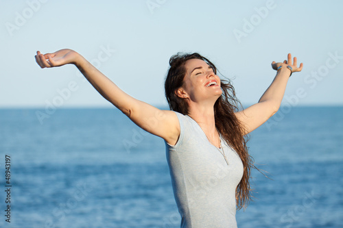 Beautiful woman with arms outstretched