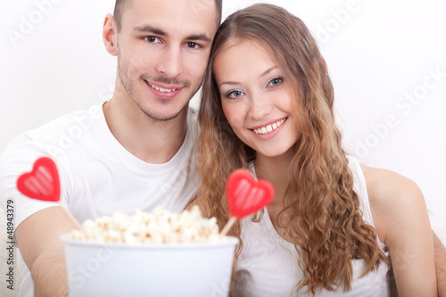 young couple sitting with popcorn
