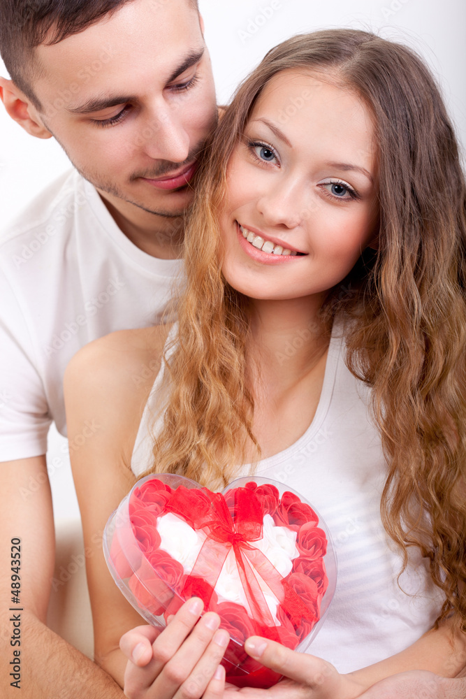 man giving heart-shaped box for his girlfriend man giving heart-shaped box for his girlfriend