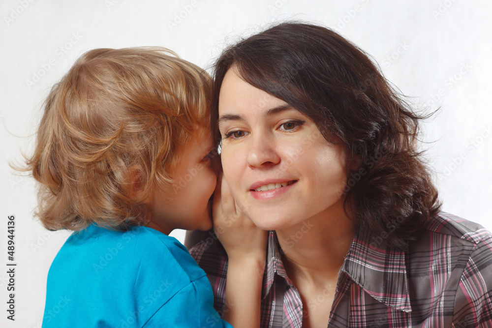Little blond boy whispers secrets to his mother Little blond boy whispers secrets to his mother