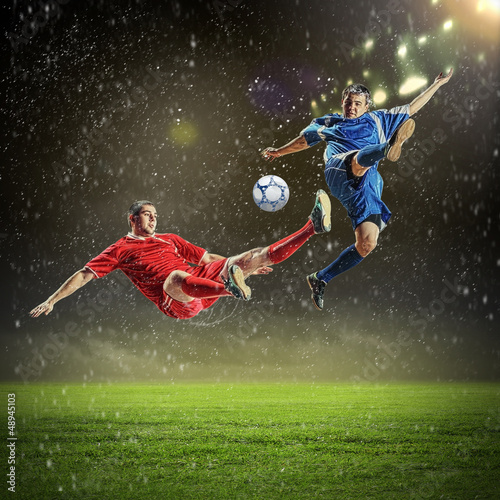 Fototapeta Naklejka Na Ścianę i Meble -  two football players striking the ball