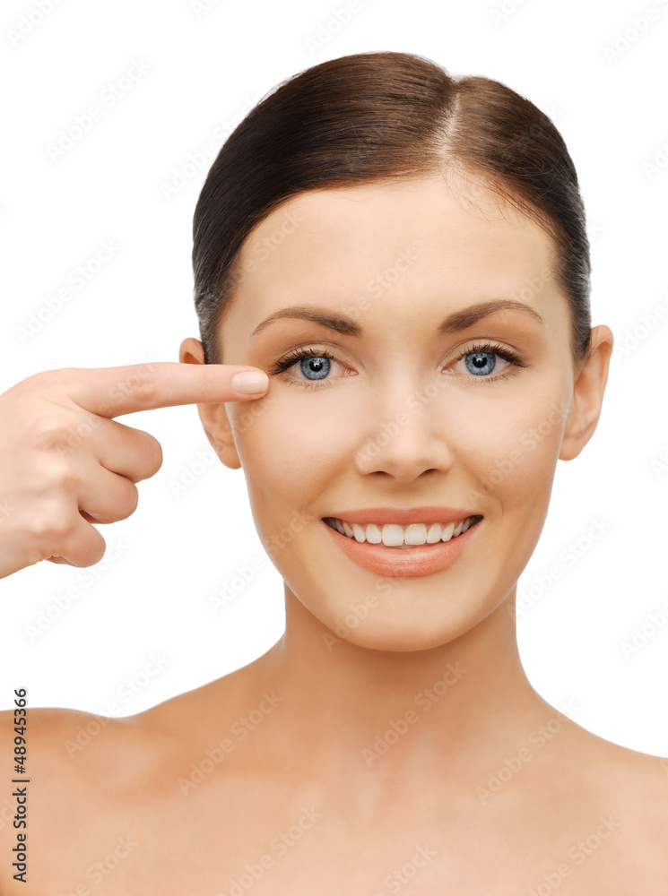 beautiful woman pointing to eye beautiful woman pointing to eye
