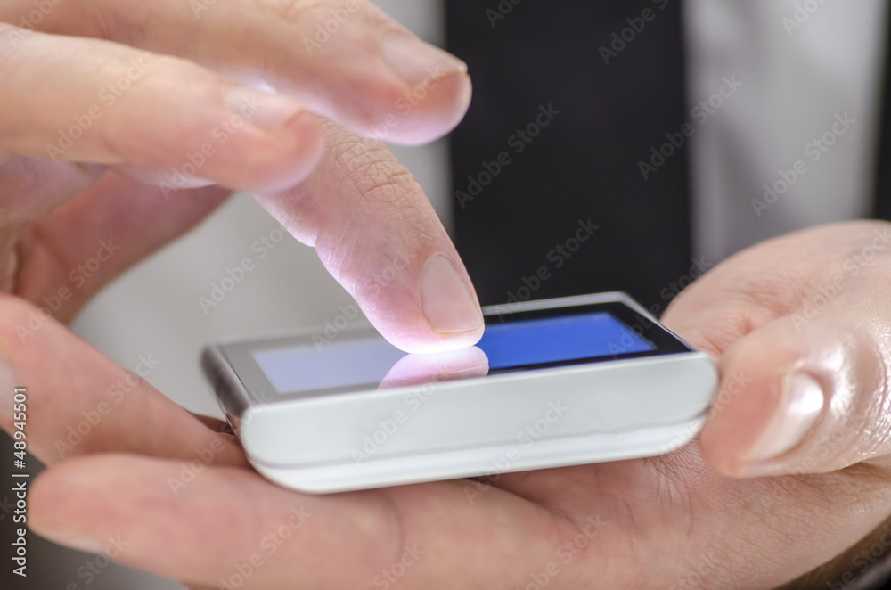 Detail of a finger touching a phone screen Detail of a finger touching a phone screen