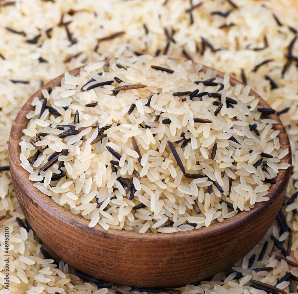 White and black rice in wooden dish