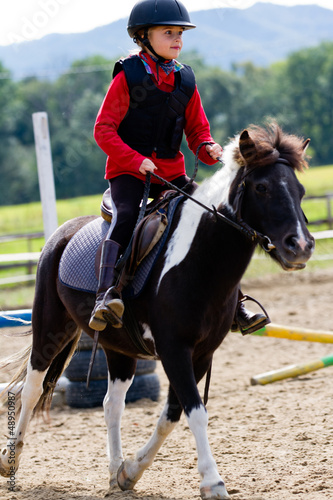 Horse riding, gallop - lovely equestrian on a pony