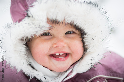 Happy baby on the winter background