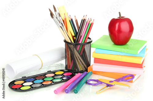 School supplies, books and apple isolated on white