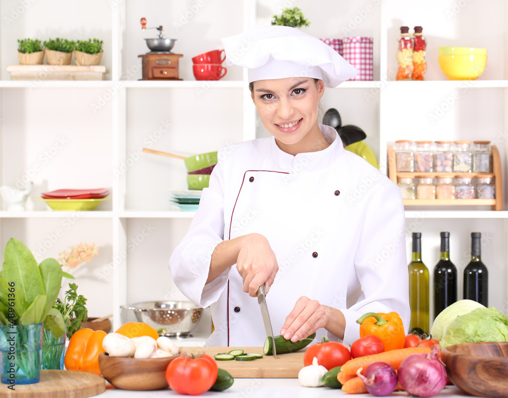 Young woman chef cooking in kitchen Young woman chef cooking in kitchen