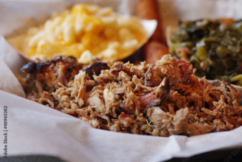 A serving of pulled pork with side dishes A serving of pulled pork with side dishes