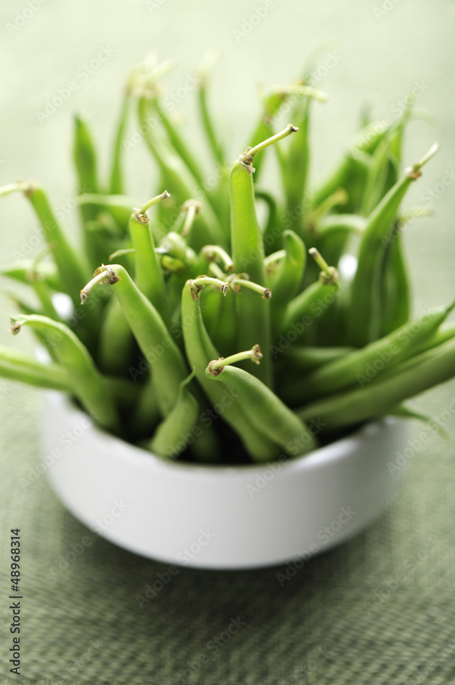 Green beans in a white bowl, selective focus. Green beans in a white bowl, selective focus.