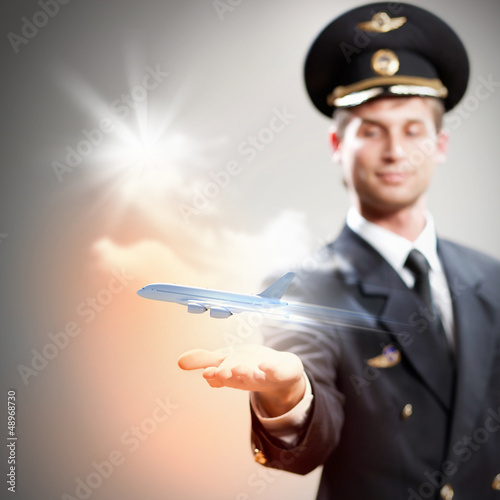 Image of pilot with plane in hand photo