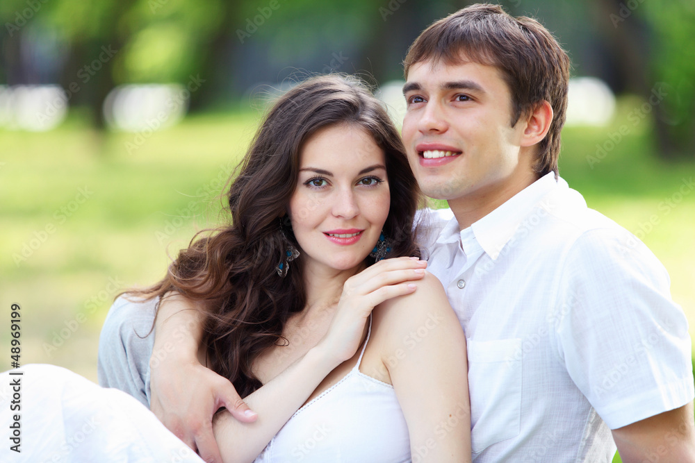Young love Couple smiling under blue sky Young love Couple smiling under blue sky