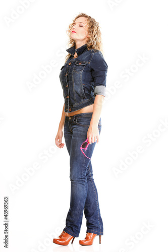 Beautiful young woman blonde standing full body in jeans isolate