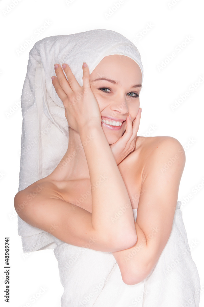 Beautiful young woman with facial mask in spa