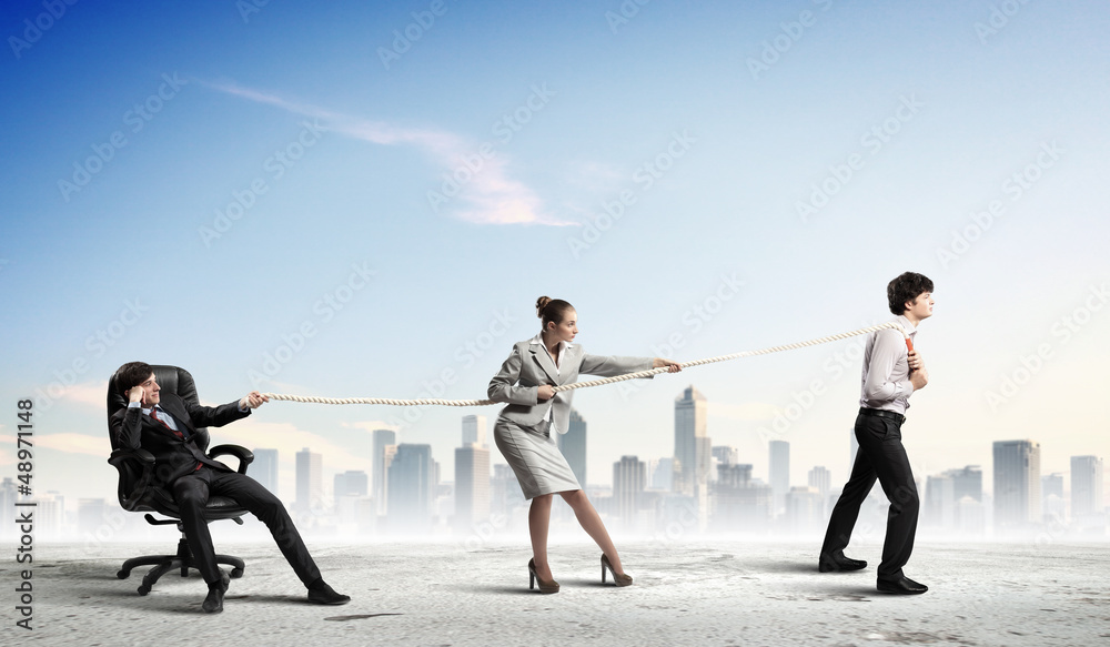 Three business people pulling rope Stock Photo