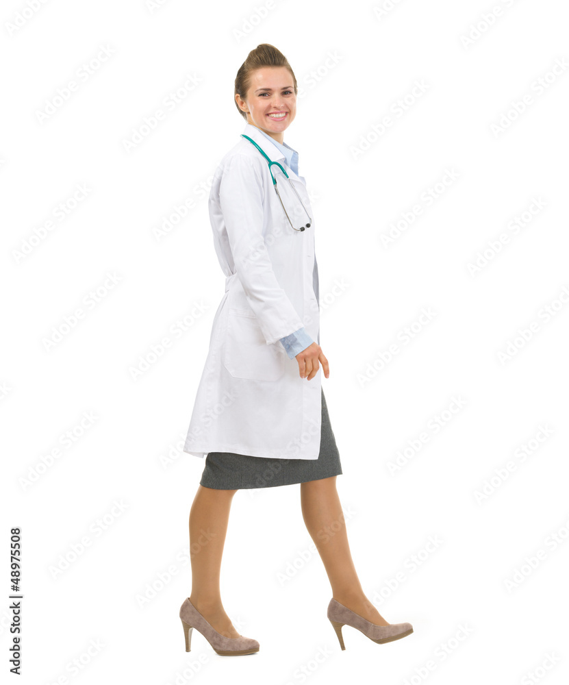 Full length portrait of medical doctor woman going sideways Full length portrait of medical doctor woman going sideways