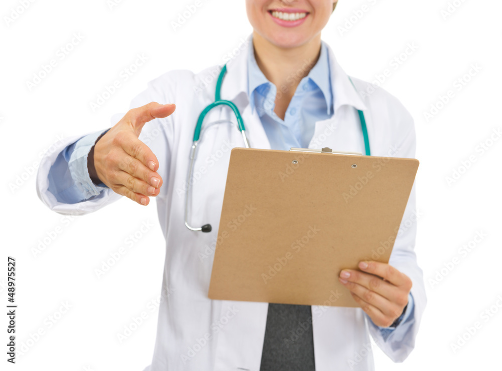 Closeup on medical doctor with clipboard stretching hand Closeup on medical doctor with clipboard stretching hand