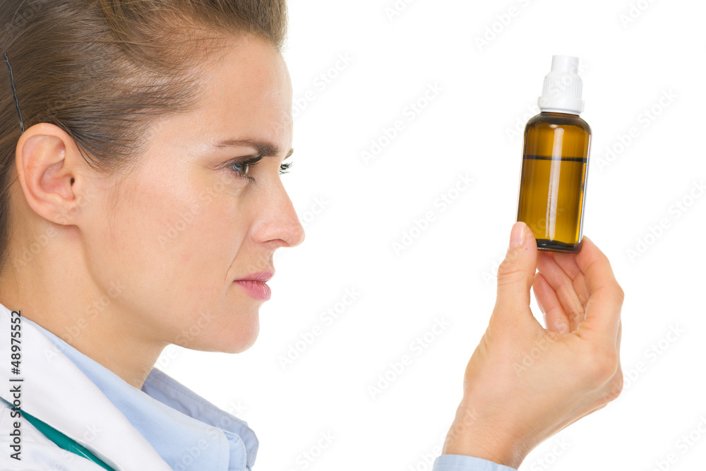 Fototapeta premium Medical doctor woman looking on medicine bottle