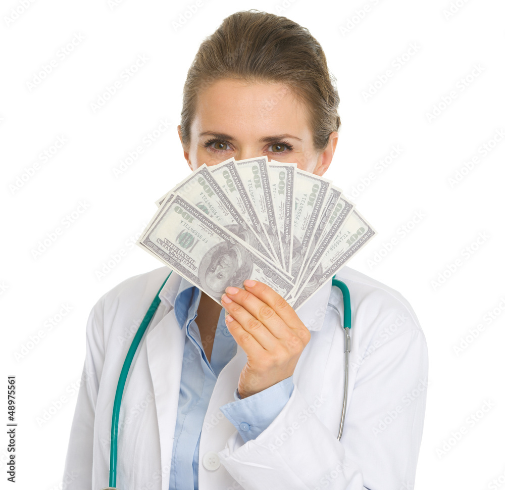 Medical doctor woman hiding behind fan of dollars Medical doctor woman hiding behind fan of dollars