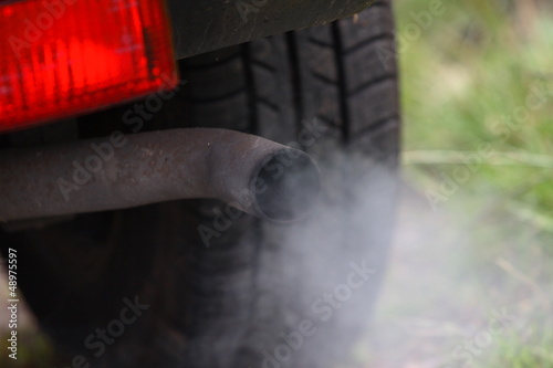 Car exhaust pollution from pipe photo