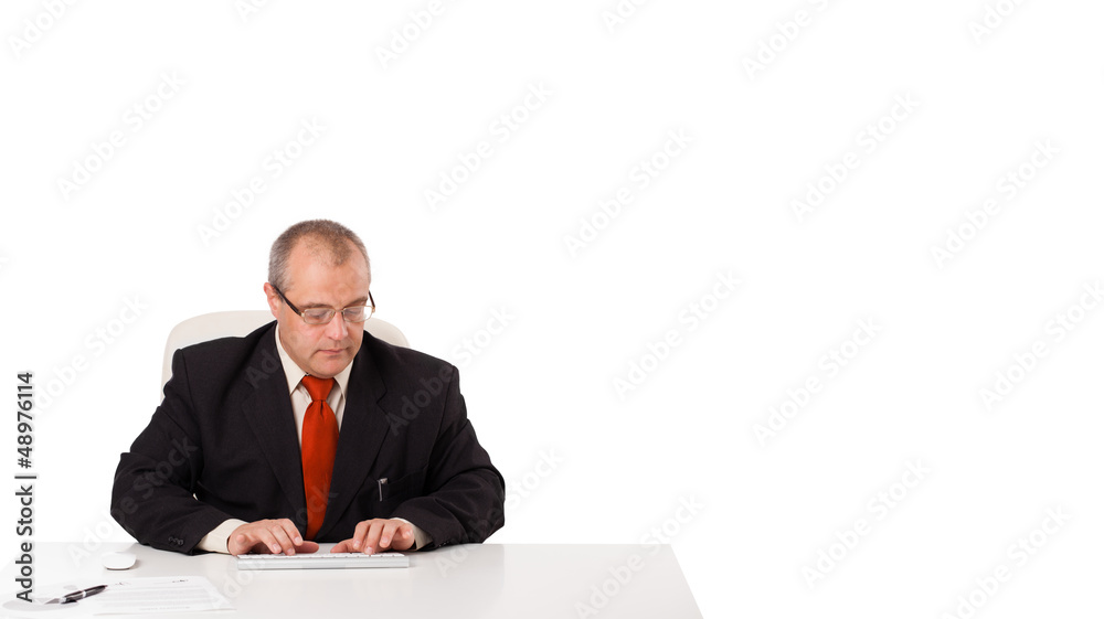 businessman sitting at desk and typing on keyboard with copy sca businessman sitting at desk and typing on keyboard with copy sca