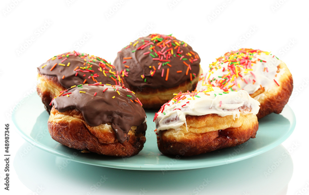 Tasty donuts on color plate isolated on white