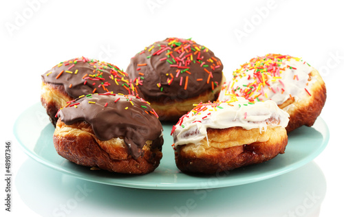Tasty donuts on color plate isolated on white