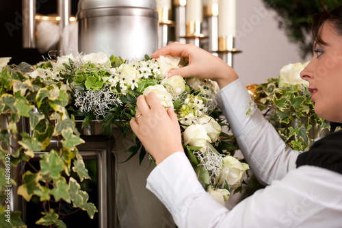 Grief - female mortician preparing urn Funeral