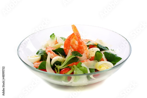 Salad with eggs, shrimp and cheese in glass bowl