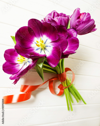 Fototapeta Naklejka Na Ścianę i Meble -  bunch of purple tulips on a  white table