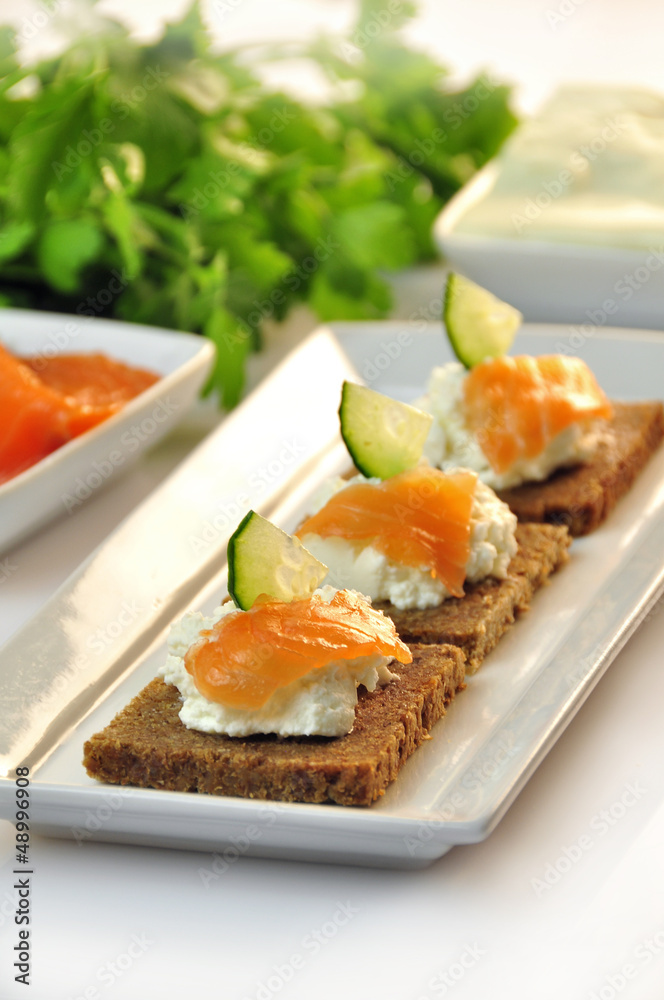 canapes rye bread with ricotta cheese and smoked salmon