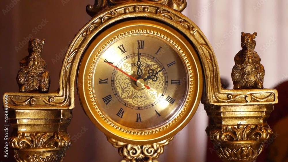 The arrows of the antique clock show 2:00.