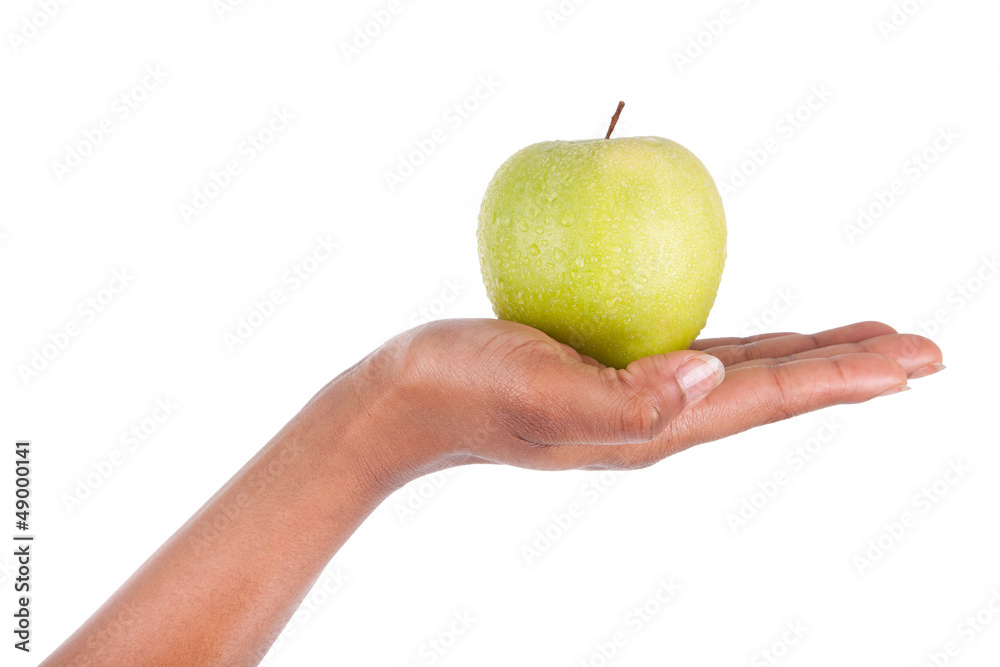 African American woman holding a fresh apple in her hand African American woman holding a fresh apple in her hand