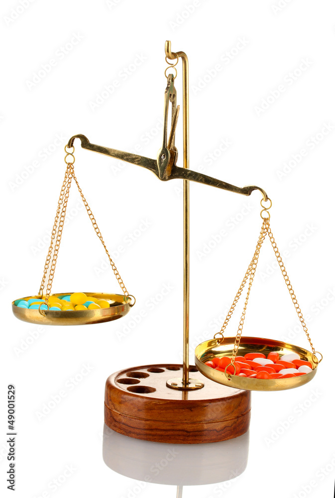 Classic scales with color pills isolated on white Classic scales with color pills isolated on white