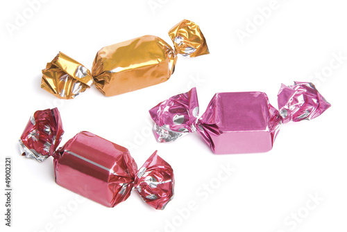 Three wrapped candies or sweets on a white background.