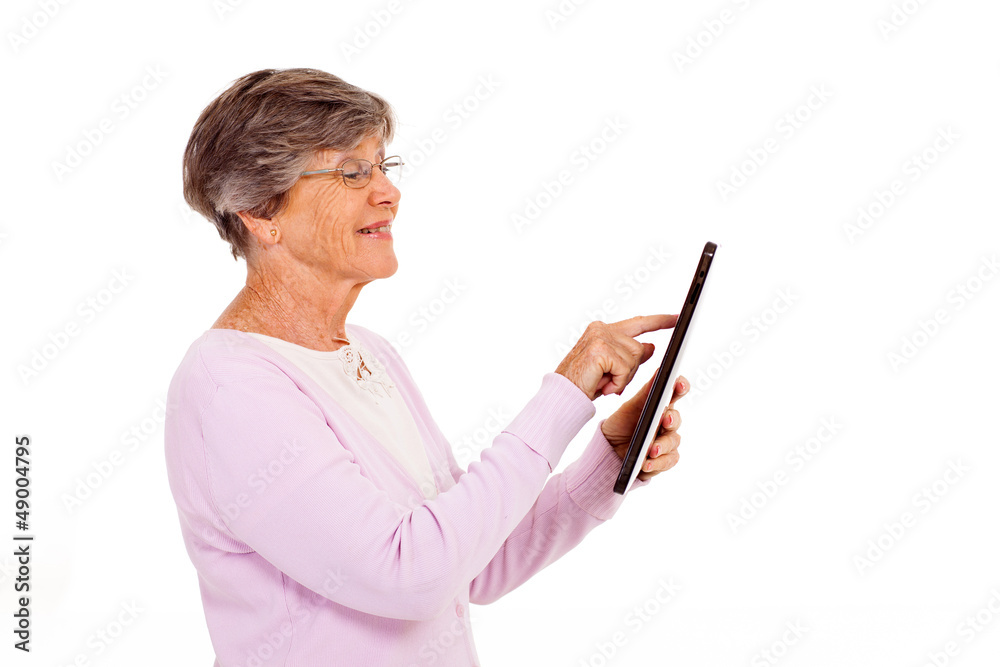 senior woman using tablet computer isolated on white senior woman using tablet computer isolated on white