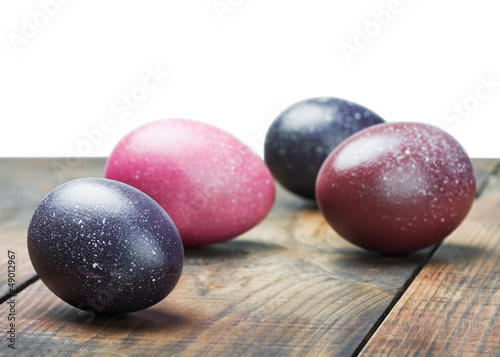 painted Easter eggs on wooden table isolated