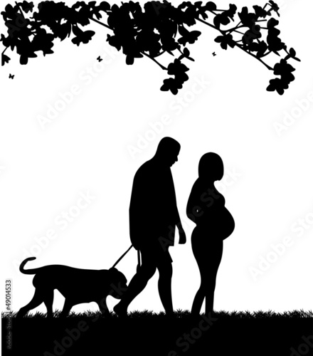 Pregnant woman and her husband walking with his dog