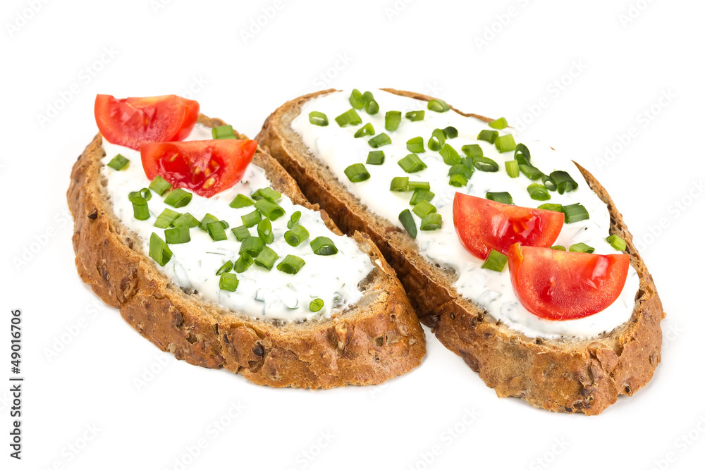 Two sandwich with cream cheese and tomatoes