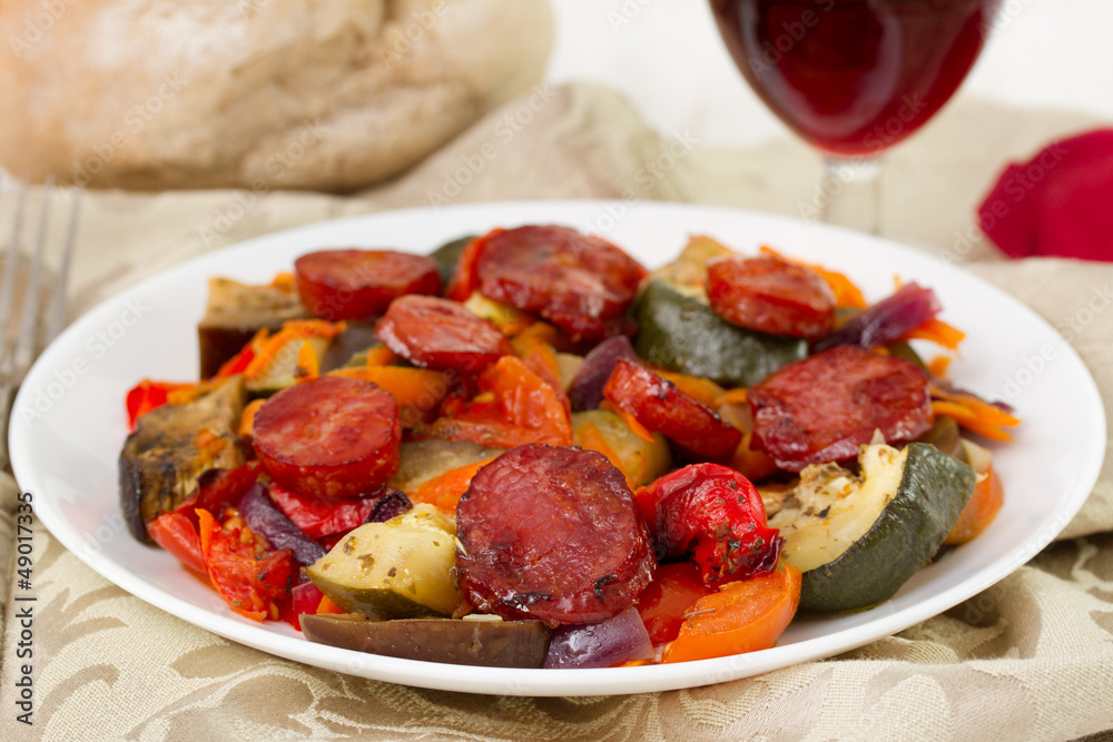 vegetables with chorizo on the white plate vegetables with chorizo on the white plate