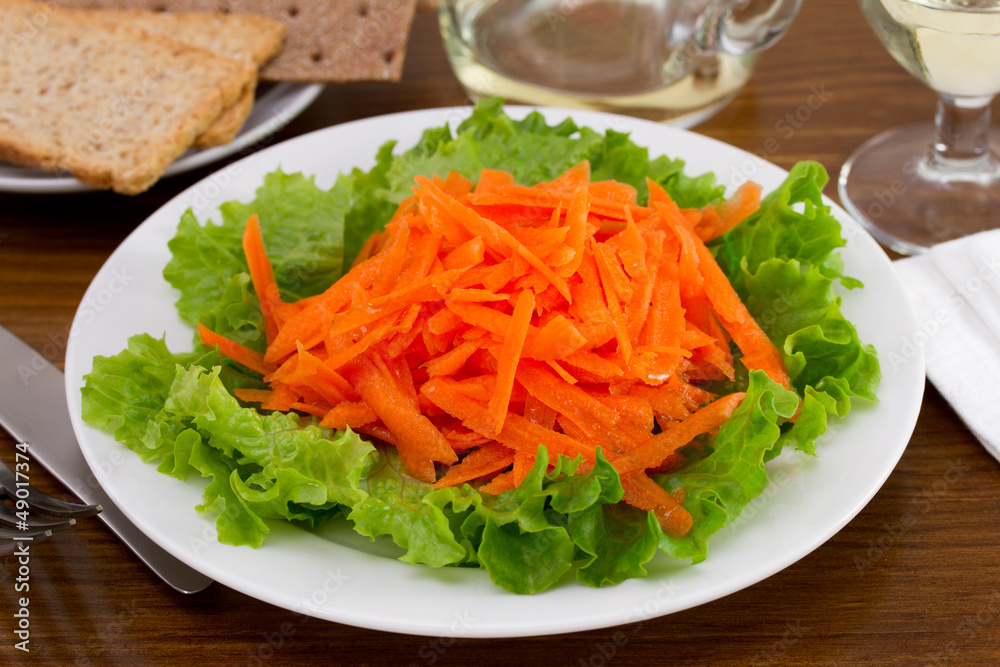 salad with fresh carrot on the white plate salad with fresh carrot on the white plate